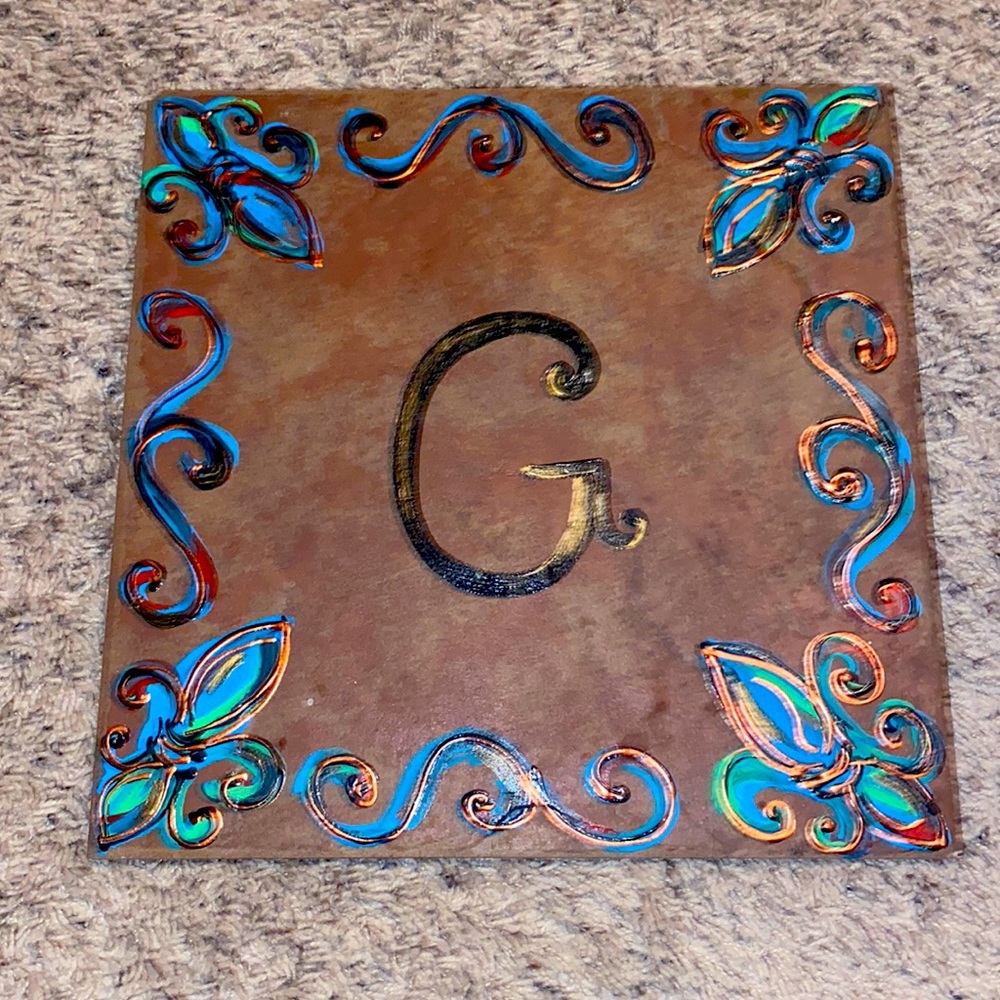 12x12 ceramic tile with G initial and designs painted